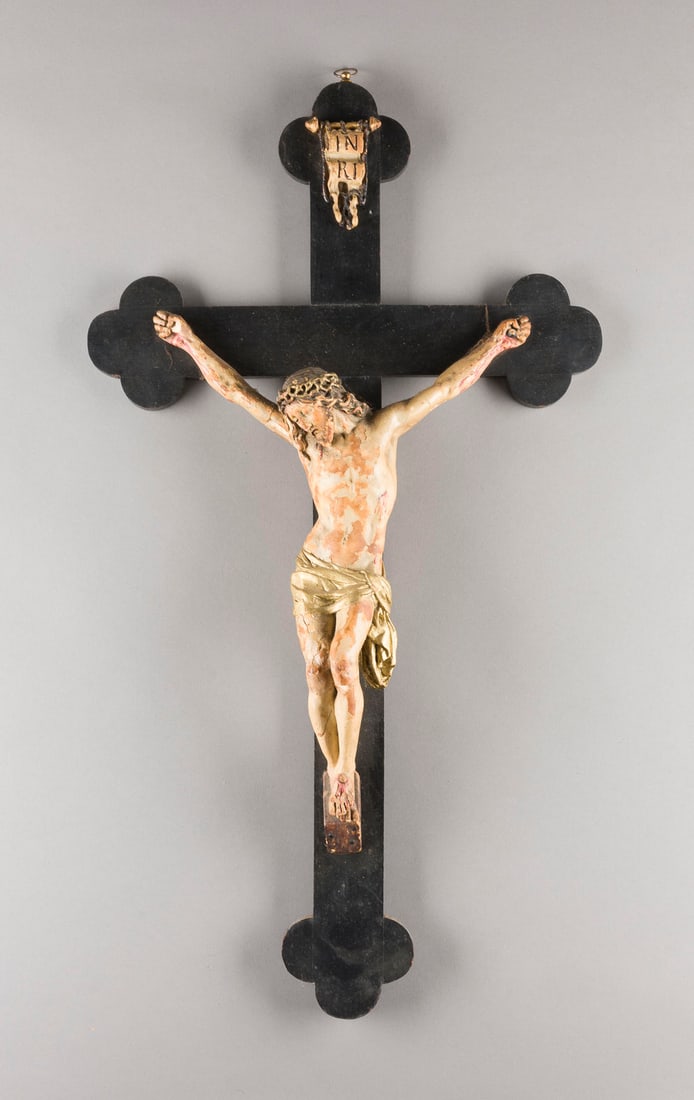 | KRUZIFIX: KRUZIFIX Deutsch, 19. Jh. Holz, plastisch geschnitzt, vergoldet, polychrom gefasst, Kreuz schwarz lackiert. H. 72,5, B. 40, T. 9 cm, Gew. ca. 1,33kg. Part. best., Fassungsverluste, Goldabrieb, besch.K