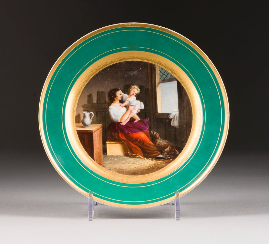 | TELLER MIT DER DARSTELLUNG EINER MUTTER MIT DEM KIND: A PORCELAIN PLATE WITH AN IMAGE OF A MOTHER WITH A CHILD Probably Russian, around 1820 Overglaze painting, gilded rims. Stamp 'ma' on the bottom. Gilding slightly rubbed. Diam 23.1 cm.TELLER MIT DER D