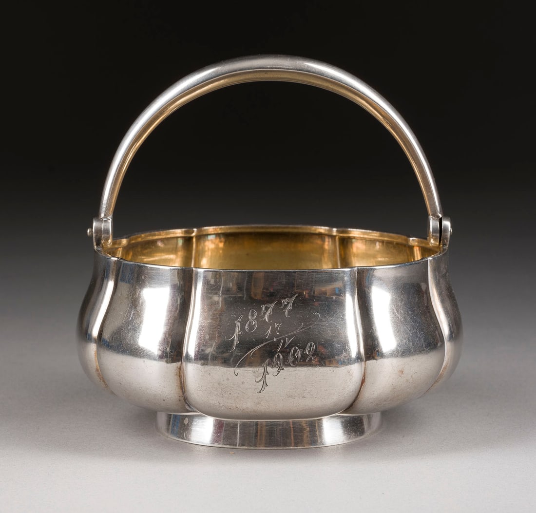 | HENKELSCHALE MIT GRAVURMONOGRAMM UND JAHRESANGABE: A SILVER BOWL WITH HANDLE Russian, St. Petersburg, Morozov, 1899-1903 Of circular form. The body engraved with initials and date. Gilt interior. Marked under base with assayer's mark, 84 standard and