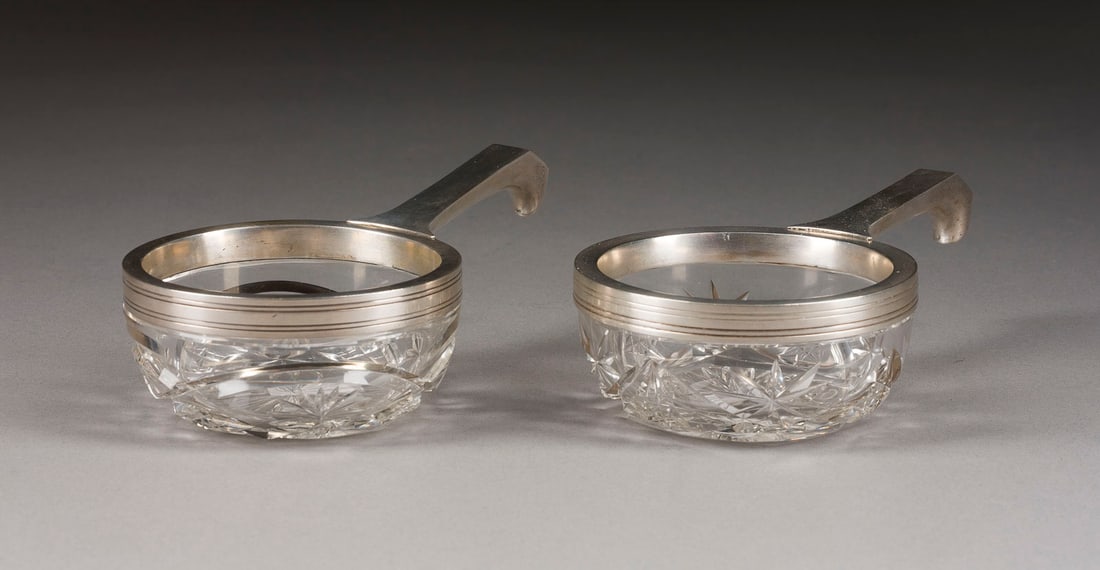 | PAAR SILBERMONTIERTE KOWSCHI: A PAIR OF SILVER-MOUNTED CUT-GLASS KOVSHI Russian, St. Petersburg, 1908-1917 Of circular form. The silver mount marked with assayer's mark, 84 standard and master's mark. Minimally chipped. 15.3 cm