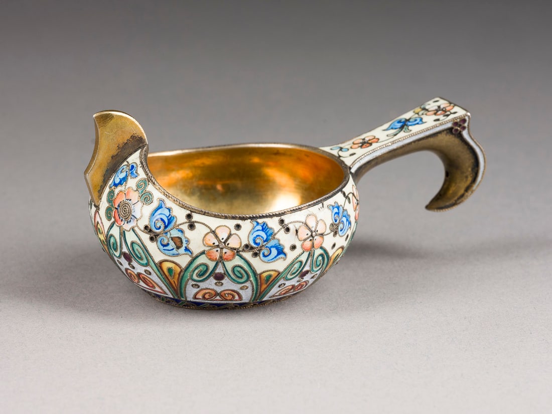 | JUGENDSTIL-CLOISONNE-EMAIL-KOWSCH: AN ART NOUVEAU CLOISONNE ENAMEL KOVSH Russian, Moscow, 11th Artel, 1908-1917 Of traditional form, with raised scroll prow and hook handle, enamelled overall with stylised scrolling foliage in shades