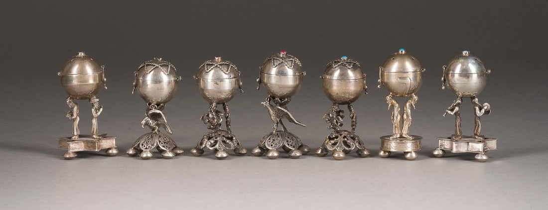 | SAMMLUNG VON SIEBEN BESAMIM-GEWUeRZDOSEN: A COLLECTION OF SEVEN SILVER BESAMIM SPICESBOXES 2nd half of the 20th century Bearing spurious Russian hallmarks. 7.7-8.3 cm high, 354 gr.SAMMLUNG VON SIEBEN BESAMIM-GEWUeRZDOSEN 2. Haelfte 20. Jh. Si