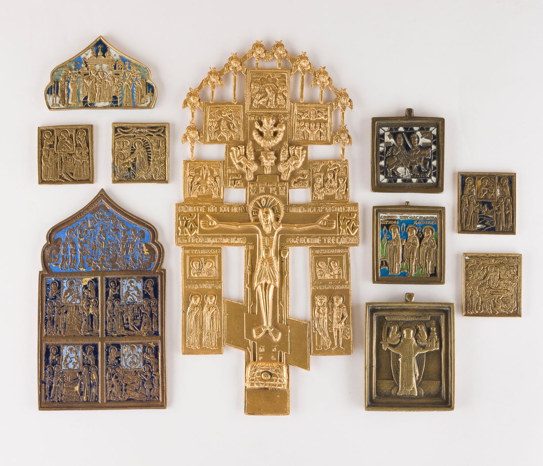 | SAMMLUNG VON ZEHN BRONZE-IKONEN: KRUZIFIX, AUSGEWAeHLTE HEILIGE SOWIE FESTTAGE: A COLLECTION OF TEN BRASS ICONS DEPICTING CRUCIFIX, SELECTED SAINTS AND LITURGICAL FEASTS Russian, 18th-20th century Cast in relief, partially multi-coloured enamelled, part. gilded. Enamel part. chip