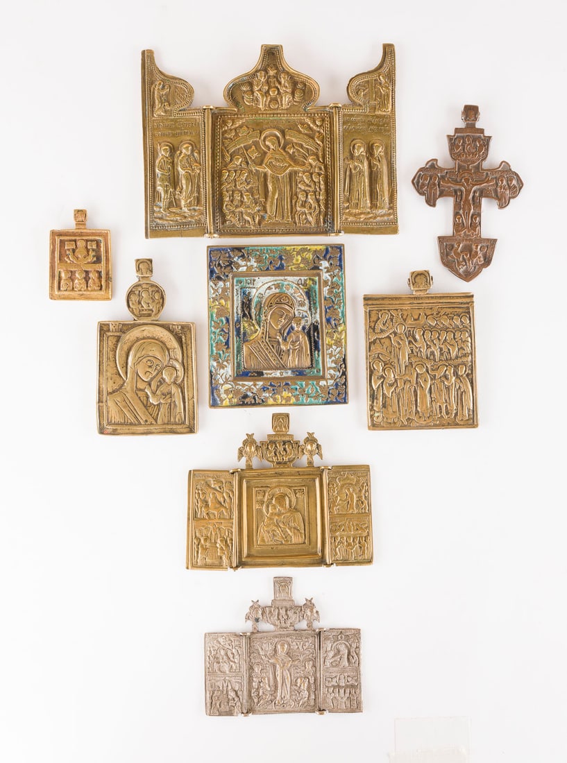 | SAMMLUNG VON ACHT BRONZE-IKONEN: KRUZIFIX SOWIE DARSTELLUNGEN DER GOTTESMUTTER: A COLLECTION OF EIGHT BRASS ICONS DEPICTING CRUCIFIX AND IMAGES OF THE MOTHER OF GOD Russian, 16th-19th century Cast in relief, partially five-colour enamelled, part. silvered. 6.3-13.3 cm high.SAMMLU