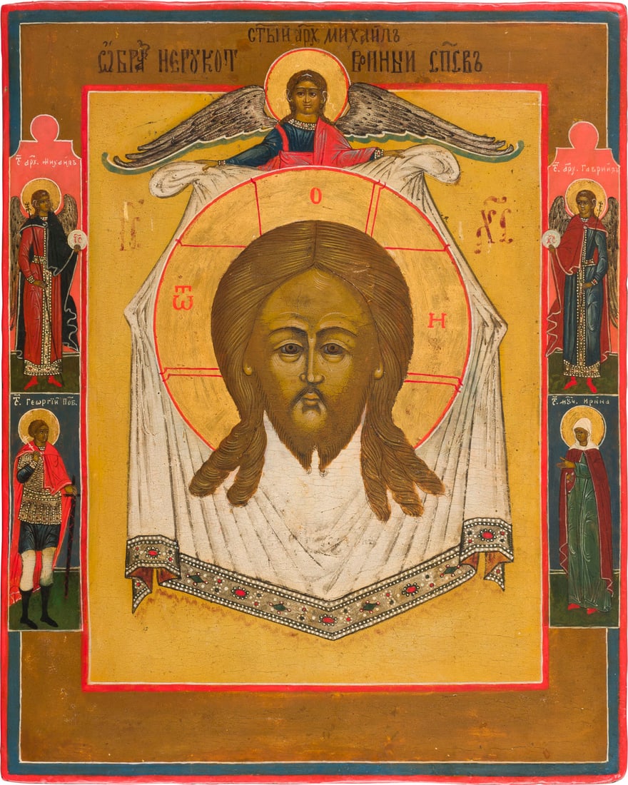 | IKONE MIT DEM MANDYLION: AN ICON SHOWING THE MANDYLION Russian, early 19th century Tempera on wood panel. The haloes made of gold. Four selected saints on the borders, the Archangel Michael and Gabriel among them. Partially r