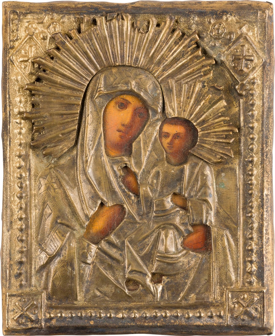 | KLEINE IKONE MIT DER GOTTESMUTTER 'IWERSKAJA' MIT OKLAD: A SMALL ICON SHOWING THE IVERSKAYA MOTHER OF GOD WITH OKLAD Russian, 19th century Oil on wood panel. The brass oklad chased and repousse. 17.7 x 14.4 cm.KLEINE IKONE MIT DER GOTTESMUTTER 'IWERSKAJA' M