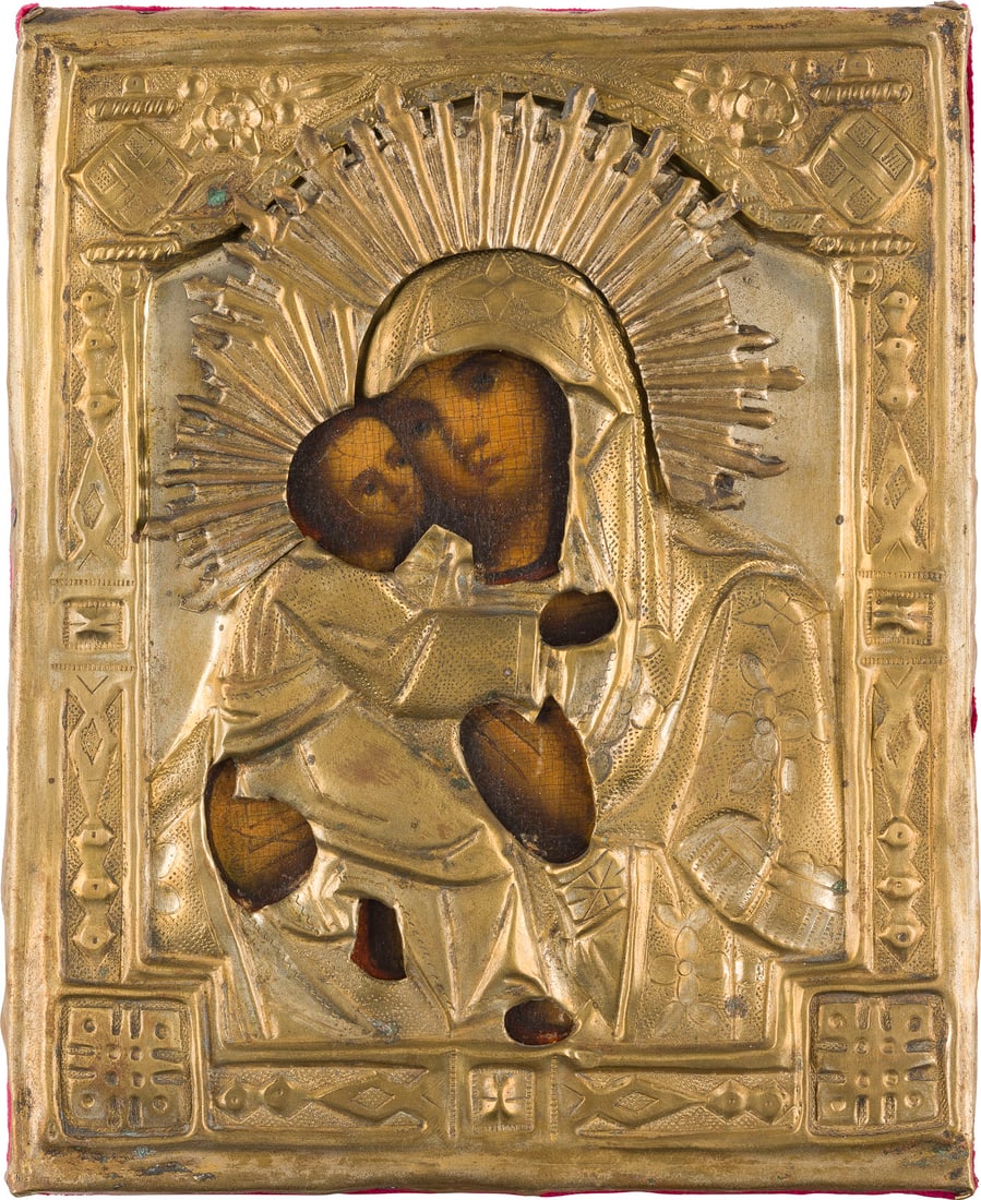 | KLEINE IKONE MIT DER GOTTESMUTTER VON WLADIMIR (WLADIMIRSKAJA) MIT OKLAD: A SMALL ICON SHOWING THE VLADIMIRSKAYA MOTHER OF GOD WITH OKLAD Russian, 19th century Oil on wood panel with cloth backing. The brass oklad chased and repousse. 17.5 x 14.2 cm.KLEINE IKONE MIT DER GOT