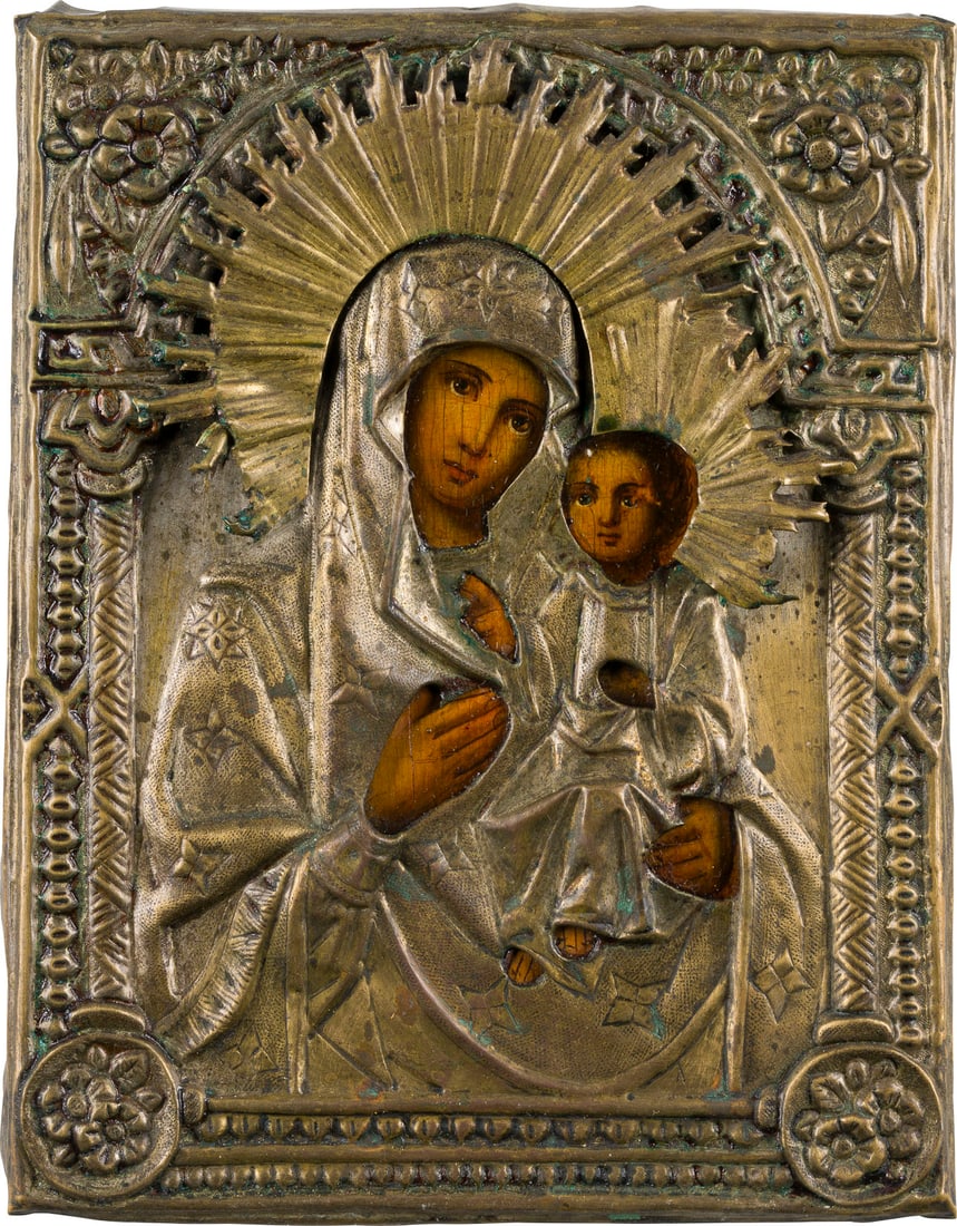 | KLEINE IKONE MIT DER GOTTESMUTTER 'IWERSKAJA' MIT OKLAD: A SMALL ICON SHOWING THE IVERSKAYA MOTHER OF GOD WITH OKLAD Russian, 19th century OIl on wood panel. The brass oklad chased and repousse. Minor losses. 22.2 x 17.4 cm.KLEINE IKONE MIT DER GOTTESMUTTER