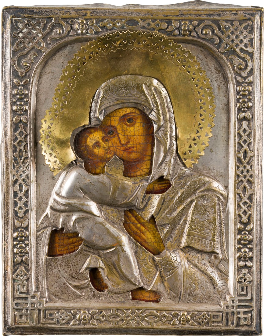 | KLEINE IKONE MIT DER GOTTESMUTTER VON WLADIMIR (WLADIMIRSKAJA) MIT OKLAD: A SMALL ICON SHOWING THE VLADIMIRSKAYA MOTHER OF GOD WITH OKLAD Russian, 2nd half of the 19th century Oil on wood panel. The brass oklad chased and embossed with strapwork. Minor losses. 22.5 x 17.8 c