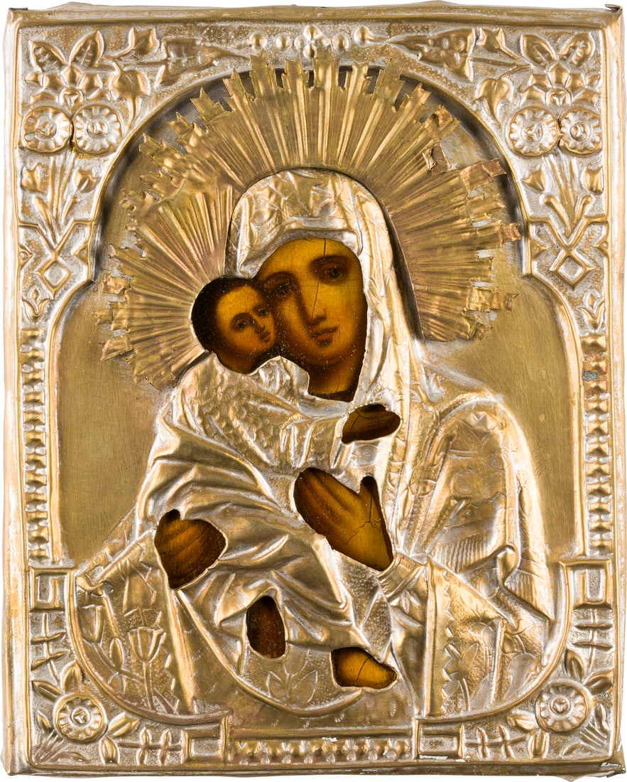 | KLEINE IKONE MIT DER GOTTESMUTTER VON WLADIMIR (WLADIMIRSKAJA) MIT OKLAD: A SMALL ICON SHOWING THE VLADIMIRSKAYA MOTHER OF GOD WITH OKLAD Russian, mid 19th century Oil on wood panel with cloth covering. The brass oklad chased and repousse. 22 x 17.8 cm.KLEINE IKONE MIT DER
