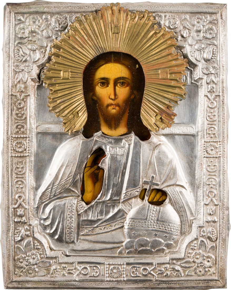 | KLEINE IKONE MIT CHRISTUS DEM WELTENHERRSCHER MIT OKLAD: A SMALL ICON SHOWING CHRIST THE SAVIOUR WITH OKLAD Russian, 19th century Oil on wood panel. The metal oklad chased and repousse. 21.8 x 17.3 cm.KLEINE IKONE MIT CHRISTUS DEM WELTENHERRSCHER MIT OKLAD