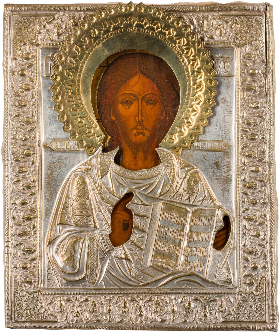 | IKONE MIT CHRISTUS PANTOKRATOR MIT OKLAD: AN ICON SHOWING CHRIST PANTOKRATOR WITH OKLAD Russian, 19th century Tempera on wood panel. The brass oklad chased and repousse. Restored. 26.2 x 21.8 cm.IKONE MIT CHRISTUS PANTOKRATOR MIT OKLAD Russla