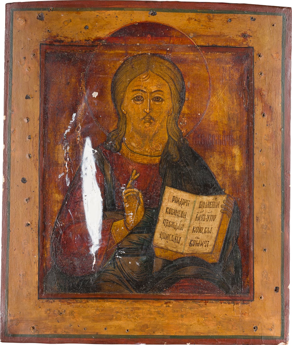 | IKONE MIT CHRISTUS PANTOKRATOR: AN ICON SHOWING CHRIST PANTOKRATOR Russian, 19th century Tempera on wood paenl with kovcheg. The background made of silver, covered by a golden lacquer. Losses, restored. 35.2 x 30.2 cm.IKONE MIT CHRI