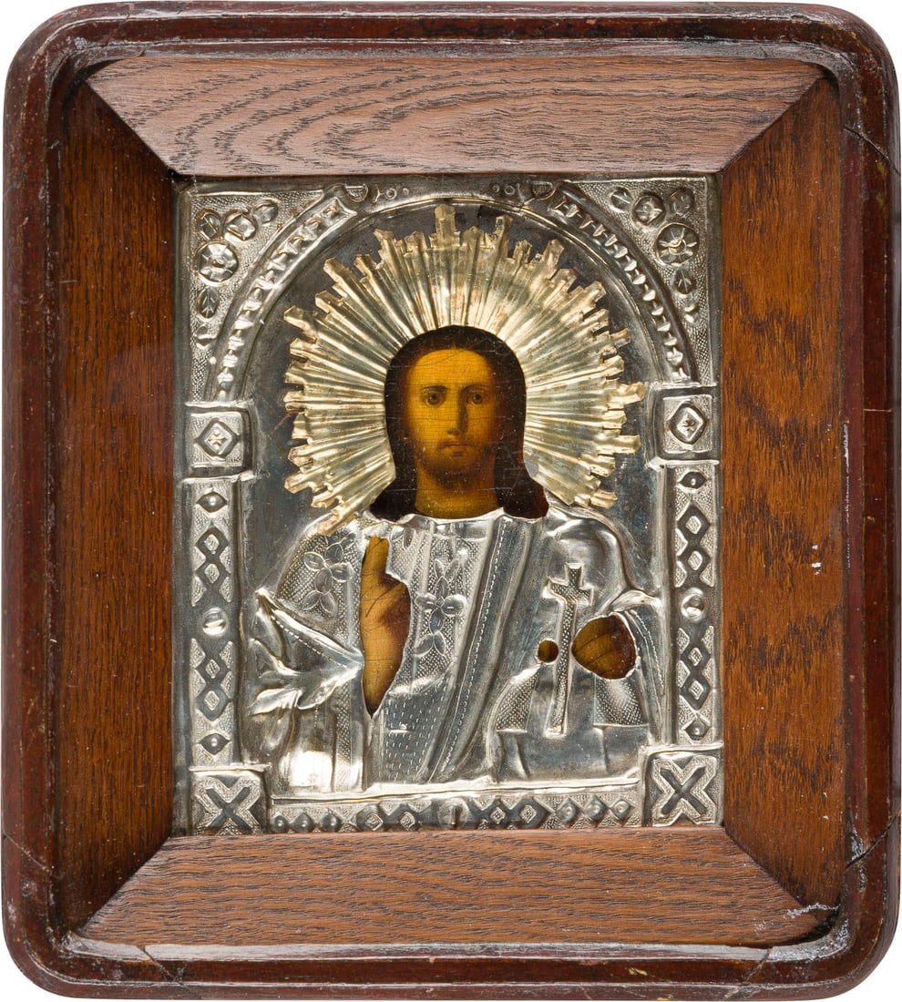 | KLEINE IKONE MIT CHRISTUS DEM WELTENHERRSCHER MIT OKLAD IM KIOT: A SMALL ICON SHOWING CHRIST PANTOKRATOR WITH OKLAD WITHIN KYOT Russian, 19th century Oil on wood panel. The brass oklad chased and repousse. 25 x 22.5 cm (with glazed kyot).KLEINE IKONE MIT CHRISTUS D