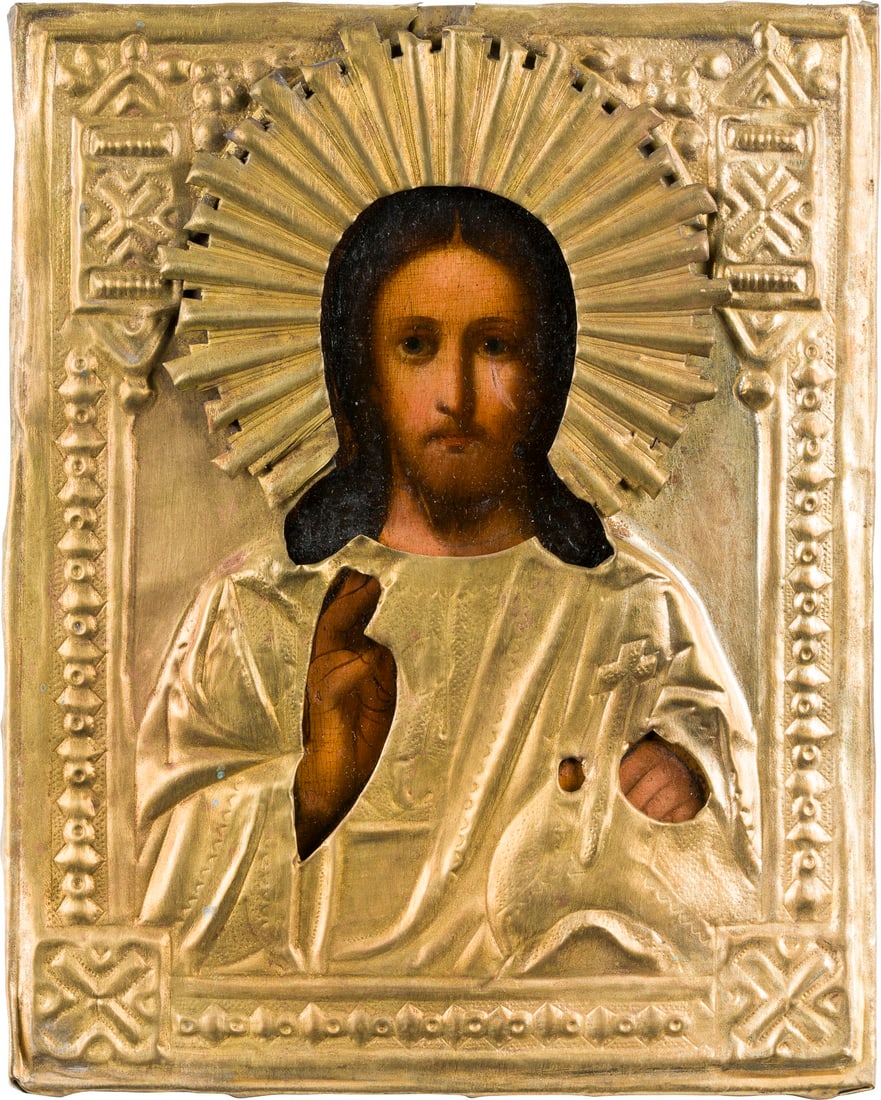 | KLEINE IKONE MIT CHRISTUS DEM WELTENHERRSCHER MIT OKLAD: A SMALL ICON SHOWING CHRIST THE SAVIOUR WITH OKLAD Russian, 19th century Oil on wood panel. The brass oklad chased and repousse. 22 x 17.7 cm.KLEINE IKONE MIT CHRISTUS DEM WELTENHERRSCHER MIT OKLAD Ru