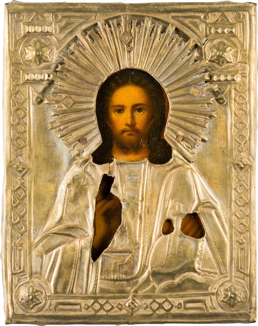 | KLEINE IKONE MIT CHRISTUS DEM WELTENHERRSCHER MIT OKLAD: A SMALL ICON SHOWING CHRIST THE SAVIOUR WITH OKLAD Russian, mid 19th century Oil on wood panel. The brass oklad chased and repousse. Minimally restored. 22.5 x 18.2 cm.KLEINE IKONE MIT CHRISTUS DEM WE