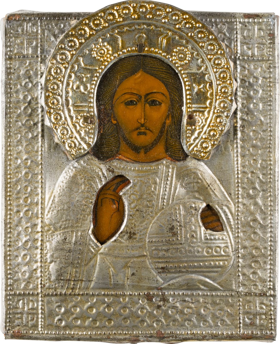 | KLEINE IKONE MIT CHRISTUS DEM WELTENHERRSCHER MIT OKLAD: A SMALL ICON SHOWING CHRIST THE SAVIOUR WITH OKLAD Russian, late 19th century Tempera on wood panel. The metal oklad chased. 17.7 x 14.4 cm.KLEINE IKONE MIT CHRISTUS DEM WELTENHERRSCHER MIT OKLAD Russ