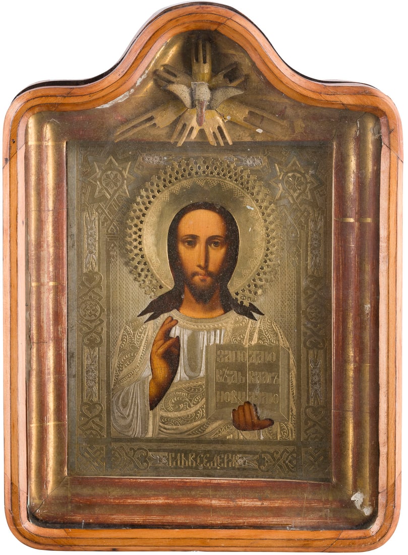 | IKONE MIT CHRISTUS PANTOKRATOR MIT OKLAD IM KIOT: AN ICON SHOWING CHRIST PANTOKRATOR WITH OKLAD WITHIN KYOT Russian, 3rd quarter 19th century Oil on wood panel. Overlaid with an engraved brass oklad. 34 x 25.3 cm (with glazed kyot).IKONE MIT CHRISTUS