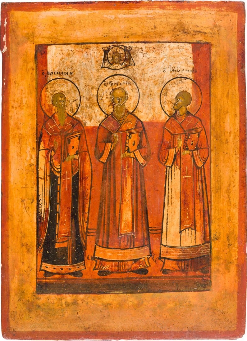 | KLEINE IKONE MIT DEN DREI HEILIGEN HIERARCHEN BASILIOS DEM GROSSEN, GREGORIOS DEM THEOLOGEN UND: A SMALL ICON SHOWING THE THREE GREAT HIERARCHS STS. BASIL THE GREAT, GREGORY THE THEOLOGIAN AND JOHN CHRYSOSTOM Russian, 19th century Tempera on wood panel. The background made of silver, covered by a