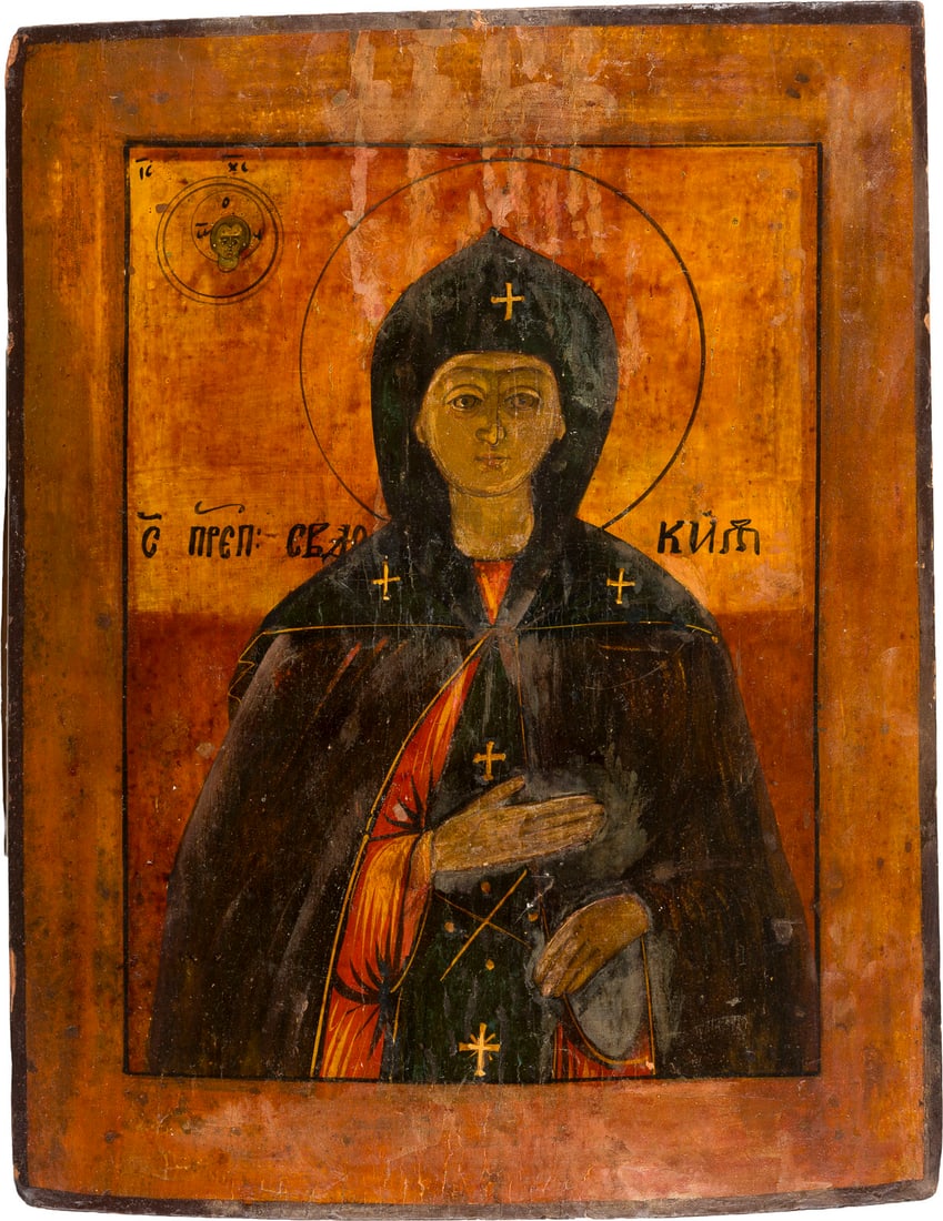 | IKONE MIT DER HEILIGEN EUDOKIA: AN ICON SHOWING ST. EUDOKIA Russian, 19th century Tempera on wood panel. Partially damaged and restored. 36.1 x 27.7 cm.IKONE MIT DER HEILIGEN EUDOKIA Russland, 19. Jh. Holztafel mit zwei Rueckseiten-