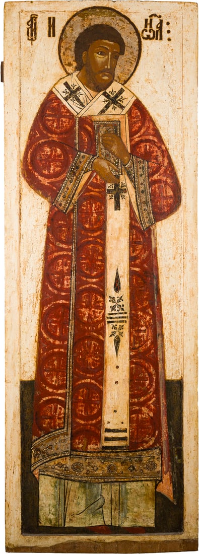 | MONUMENTALE IKONE MIT DEM HEILIGEN JOHANNES CHRYSOSTOMUS AUS EINER KIRCHEN-IKONOSTASE: A MONUMENTAL ICON SHOWING ST. JOHN CHRYSOSTOM FROM A CHURCH ICONOSTASIS Russian, 17th century Tempera on wood panel with kovcheg. The halo made of silver. The background and border stripped to gesso,