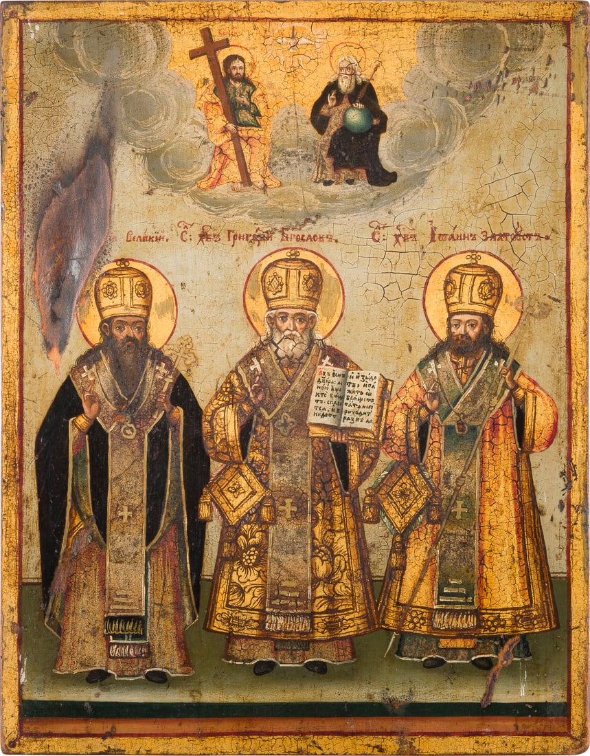 | IKONE MIT DEN DREI HIERARCHEN BASILIUS DEM GROSSEN, GREGOR DEM THEOLOGEN UND JOHANNES CHRYSOSTOMUS: AN ICON SHOWING THREE HIERARCHS OF ORTHODOXY CHRYSOSTOMUS Balkans, circa 1875 Balkan, um 1875 Oil on wood panel. The haloes and garments executed in gold. Various inscriptions on the reverse, one date