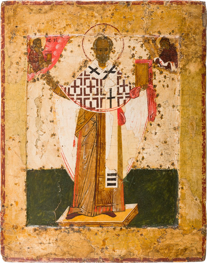 | SEHR FEINE IKONE MIT DEM HEILIGEN NIKOLAUS VON MOSCHAISK: A VERY FINE ICON SHOWING ST. NICHOLAS OF MOZHAISK Russian, 16th century Tempera on wood panel with kovcheg. Traditionally painted in subtle colours, the saint shown full length, with Christ and the Mo