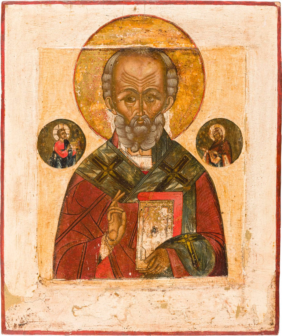 | IKONE MIT DEM HEILIGEN NIKOLAUS VON MYRA: AN ICON SHOWING ST. NICHOLAS OF MYRA Russian, Old Believers' Workshop, early 19th century Tempera on wood panel with kovcheg. The haloes made of gold. The background and border stripped to gesso, wear