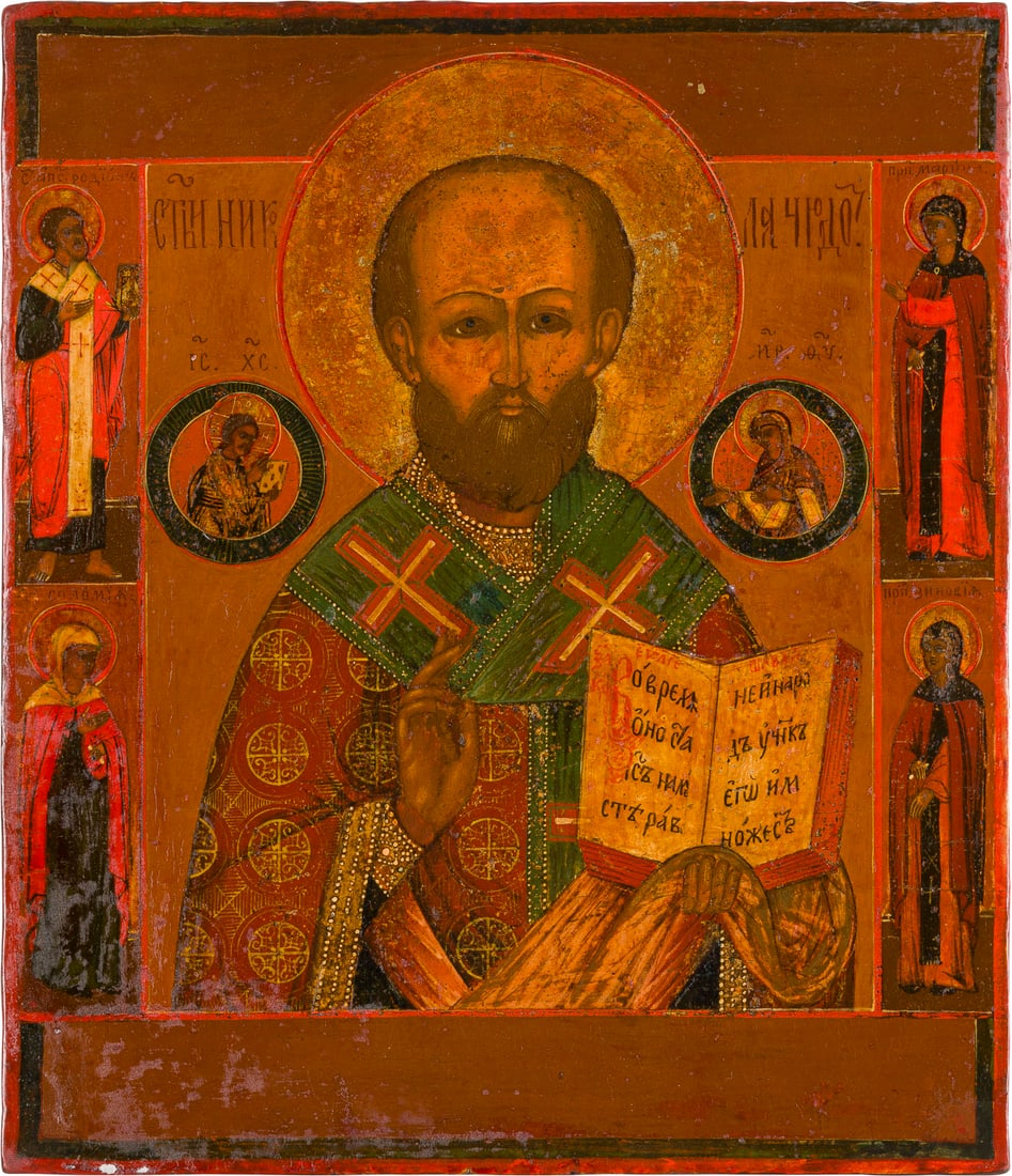 | IKONE MIT DEM HEILIGEN NIKOLAUS VON MYRA: AN ICON SHOWING ST. NICHOLAS OF MYRA Russian, 19th century Tempera on wood panel. The halo made of silver, covered by a golden lacquer. Four selected saints on the borders, St. Zinobia among them. Par
