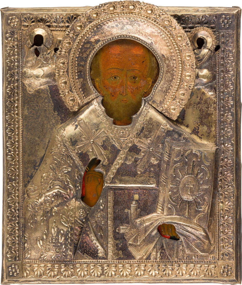 | IKONE MIT DEM HEILIGEN NIKOLAUS VON MYRA MIT OKLAD: AN ICON SHOWING ST. NICHOLAS OF MYRA WITH OKLAD Russian, Yaroslavl, late 18th century (icon), Russian, early 19th century (oklad) Tempera on wood panel. The background made of silver, covered by a gol
