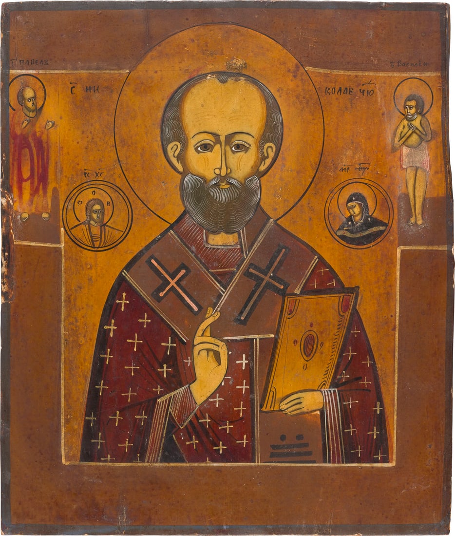 | IKONE MIT DEM HEILIGEN NIKOLAUS VON MYRA: AN ICON SHOWING ST. NICHOLAS OF MYRA Russian, 19th century Tempera on wood panel. Two selected saints on the borders. Damages to the edges. 31.1 x 26.6 cm.IKONE MIT DEM HEILIGEN NIKOLAUS VON MYRA Russ