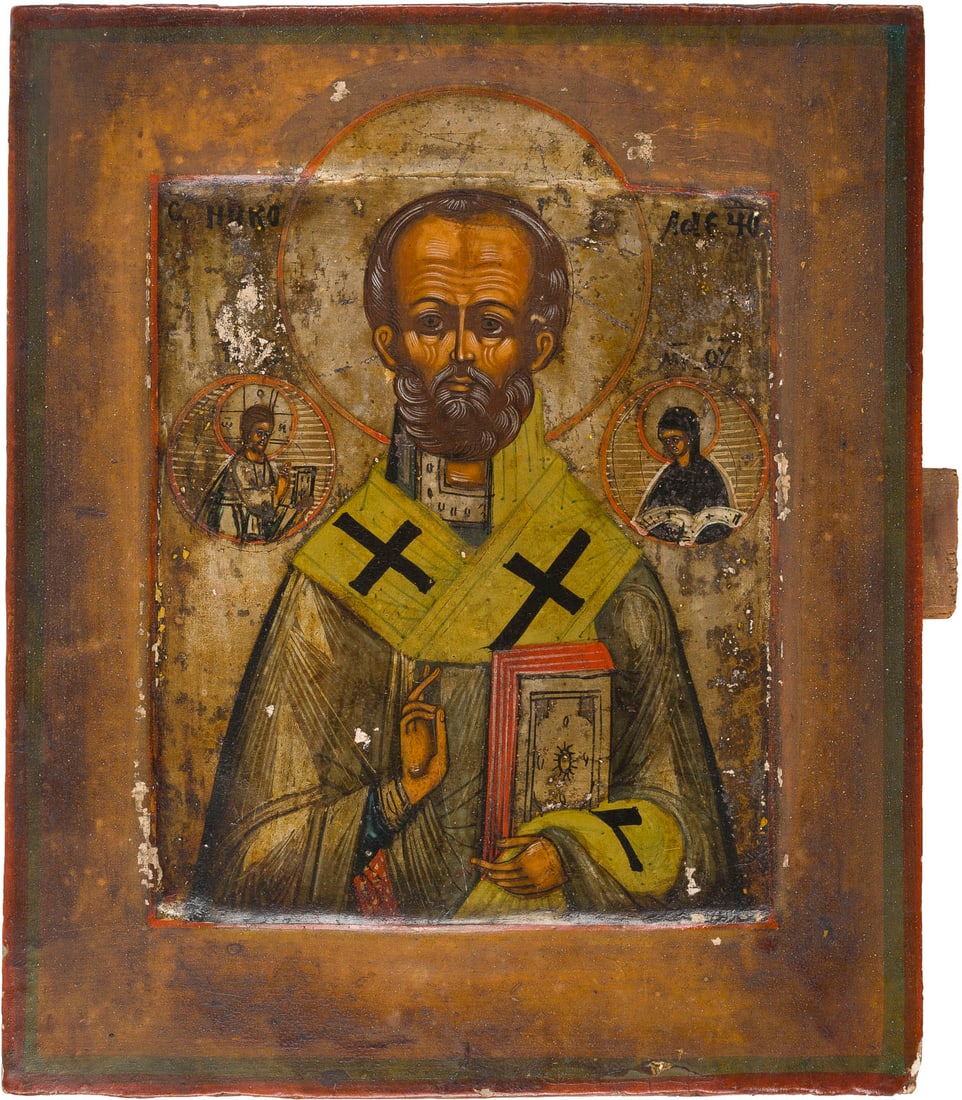| KLEINE IKONE MIT DEM HEILIGEN NIKOLAUS DEM WUNDERTAeTER: A SMALL ICON SHOWING ST. NICHOLAS OF MYRA Russian, 19th century Tempera on wood panel with kovcheg. The background made of silver, covered by a golden lacquer. Minimally restored. 17.3 x 14.5 cm.KLEIN