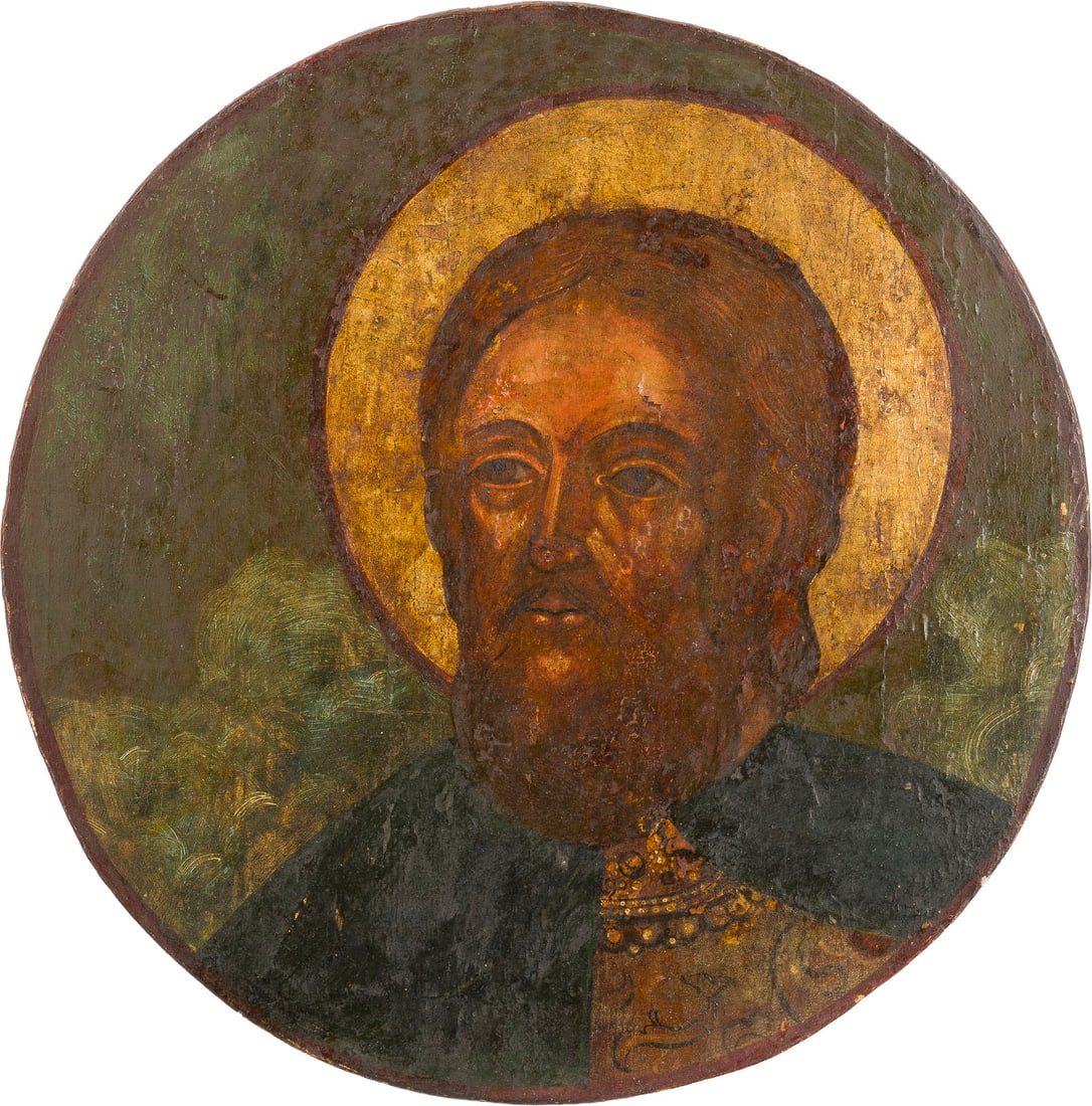 | GROSSE IKONE MIT EINEM HEILIGEN (ALEXANDER NEWSKI?): A LARGE ICON DEPICTING A SAINT (ALEXANDER NEVSKY?) Russian, circa 1700 Tempera on wood panel. The halo made of silver, covered by a golden lacquer. Partially restored. Diam. 36.2 cm.GROSSE IKONE MIT E