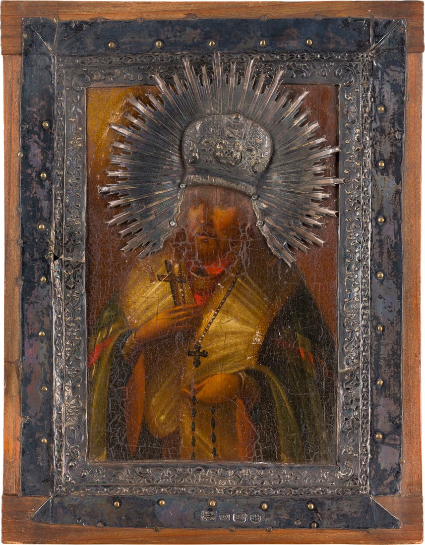 | KLEINE IKONE MIT DEM HEILIGEN MITROFAN VON WORONESCH MIT SILBER-BASMA: A SMALL ICON SHOWING ST. MITROPHAN OF VORONEZH WITH SILVER BASMA Russian, after 1832 (icon), Russian, St. Petersburg, Dmitriy Andreev, 1836 (basma) Oil on wood panel. The borders chased and repousse w