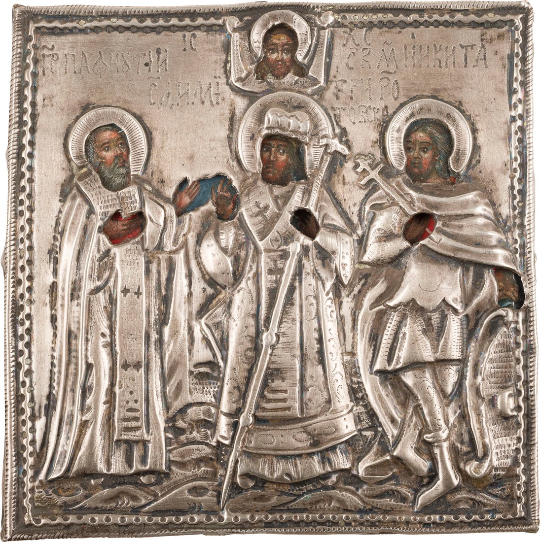 | KLEINE IKONE MIT DEN HEILIGEN PAFNUTIJ, DMITRIJ VON ROSTOW UND NIKITA MIT SILBER-OKLAD: A SMALL ICON SHOWING STS. PAFNUTIY, DMITRIY OF ROSTOV AND NIKITA WITH A SILVER OKLAD Russian, circa 1780 (icon), Russian, Moscow, 1782 (oklad) Tempera on wood panel. The silver oklad chased and repous