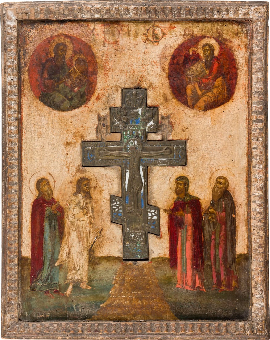 | GROSSFORMATIGE STAUROTHEK MIT DER KREUZIGUNG, HEILIGEN UND EVANGELISTEN: A LARGE ICON SHOWING THE CRUCIFIXION FLANKED BY SAINTS AND EVANGELISTS Russian, 18th century Tempera on wood panel with kovcheg. A brass and enamel crucifix set into the panel. The background stripped
