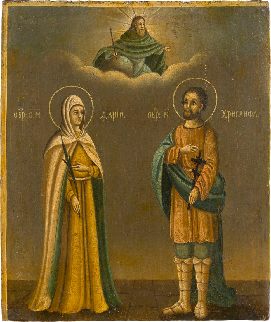 | IKONE MIT DEN HEILIGEN MAeRTYRERN CHRYSANTHUS UND DARIA: AN ICON SHOWING THE MARTYR SAINTS CHRYSANTHUS AND DARIA Russian, 2nd half of the 19th century Oil on wood panel. The edges partially cut, minimally restored. 26.3 x 22.2 cm.IKONE MIT DEN HEILIGEN MAeR