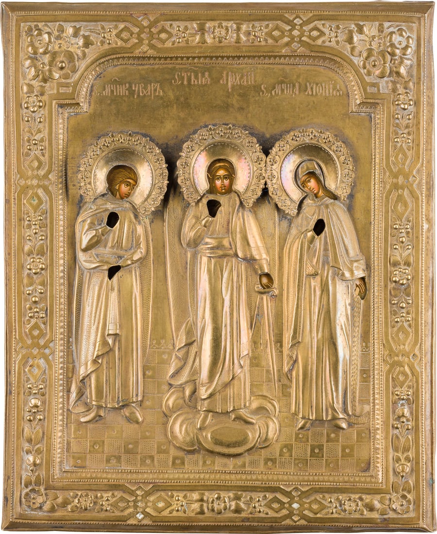 | IKONE MIT DEM SCHUTZENGEL FLANKIERT VON DEN HEILIGEN VARUS UND CHIONIA MIT OKLAD: AN ICON SHOWING THE GUARDIAN ANGEL FLANKED BY STS. VARUS AND HIONIA WITH OKLAD Russian, 2nd half of the 19th century Tempera on wood panel with cloth backing. The brass oklad chased and repousse. Larg