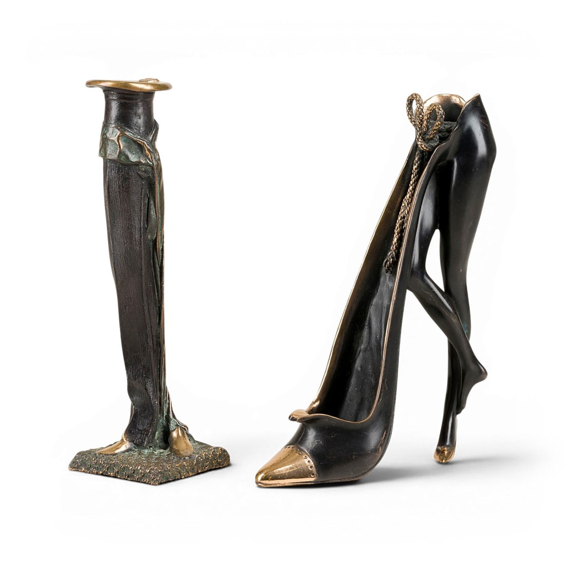GILBERT KRUFT | ZWEI FIGUERLICHE KERZENHALTER: GILBERT KRUFT 1939 Cologne - 2015 Bologna ZWEI FIGURATIVE CANDLE HOLDERS Bronze, dark/green patinated, partly polished. 23.5 x 7 x 6.5 resp. 23 x 16.5 x 6.5 cm. Total weight 2.6 kg. Each with artist's