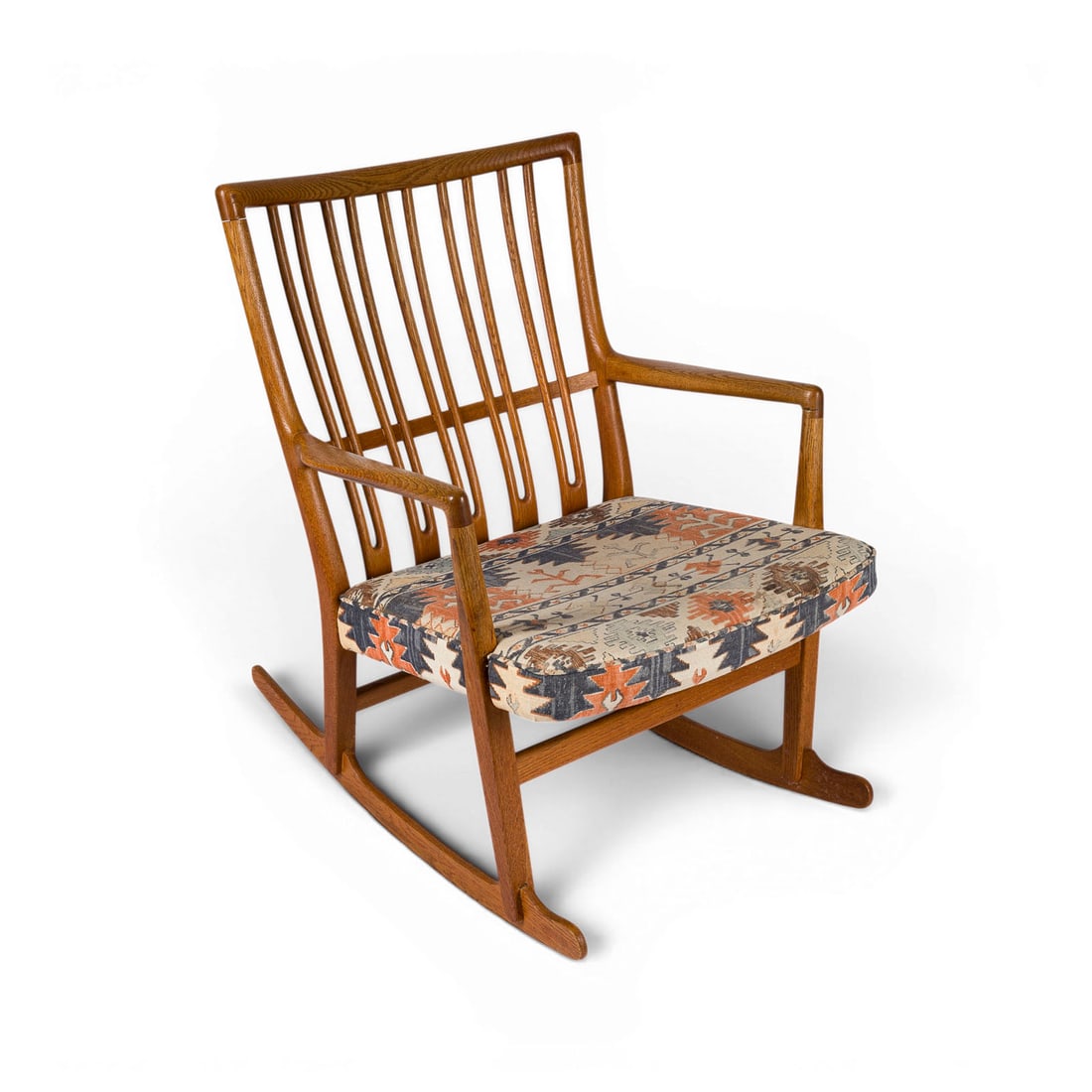 HANS J. WEGNER | SCHAUKELSTUHL 'ML 33': HANS J. WEGNER 1914 Tondern - 2007 Copenhagen A 'ML 33' ROCKING CHAIR Denmark, Mikael Laursen, designed in 1940 Oak, seat cushion w. fabric cover. H. 80cm, W. 62 cm, D. 75 cm. Traces of use, one armre
