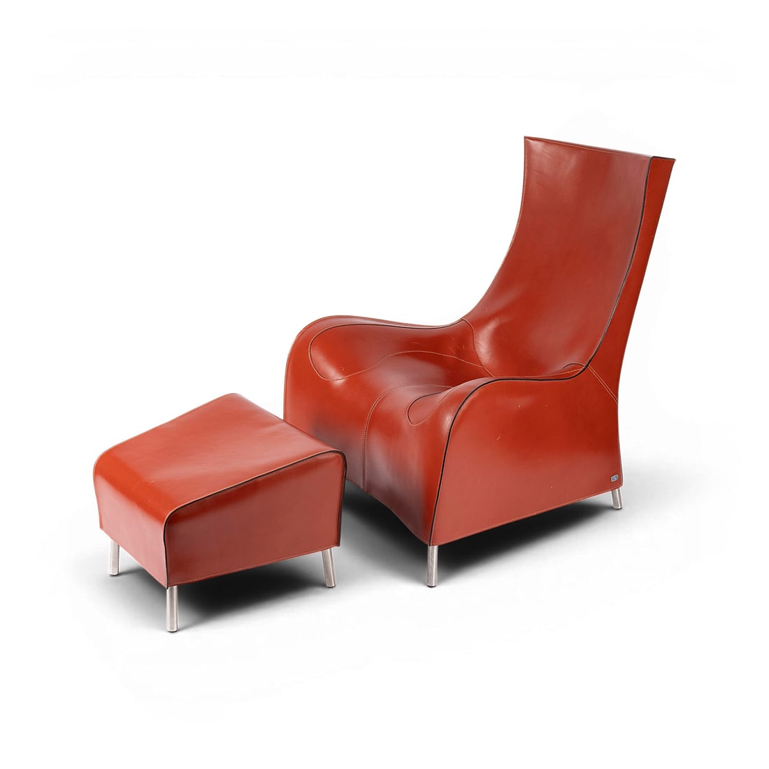 MATHIAS HOFFMANN | SESSEL UND HOCKER 'DS 264': MATHIAS HOFFMANN 1954 Ulm A 'DS 264' ARMCHAIR AND STOOL Switzerland, De Sede, designed around 1990 Frame construction, brown leather upholstery, stainless steel legs. H. 100 cm, W. 77 cm, D. 87 cm (ar