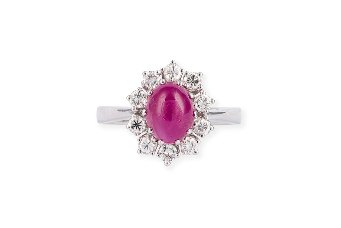 RUBIN BRILLANT RING: RUBIN BRILLANT RING WG 585. Ringmass: ca. 57,5. Ringkopfmasse: ca. 14,6 x 12,2 m. Ges.-Gew.: ca. 4,8 g. Ring, besetzt mit einem Rubin-Cabochon von ca. 2.80 ct. und einem Kranz aus Brillanten F-G/VVS-V