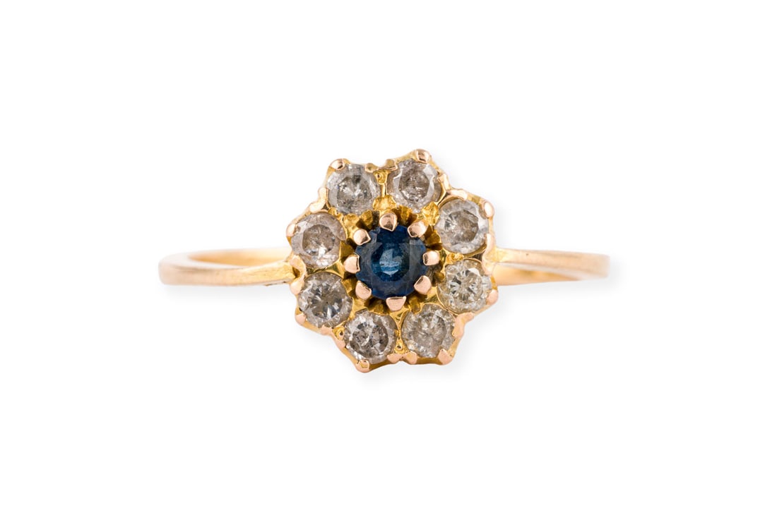 ZARTER SAPHIR HALO RING: ZARTER SAPHIR HALO RING GG 750 (getestet). Ringmass: ca. 55. D.(Ringkopf): ca. 9,3 mm. Ges.-Gew.: ca. 2,5 g. Ring, besetzt mit einem kleinen, zentralen Saphir und einem Kranz aus Diamanten zus. ca.