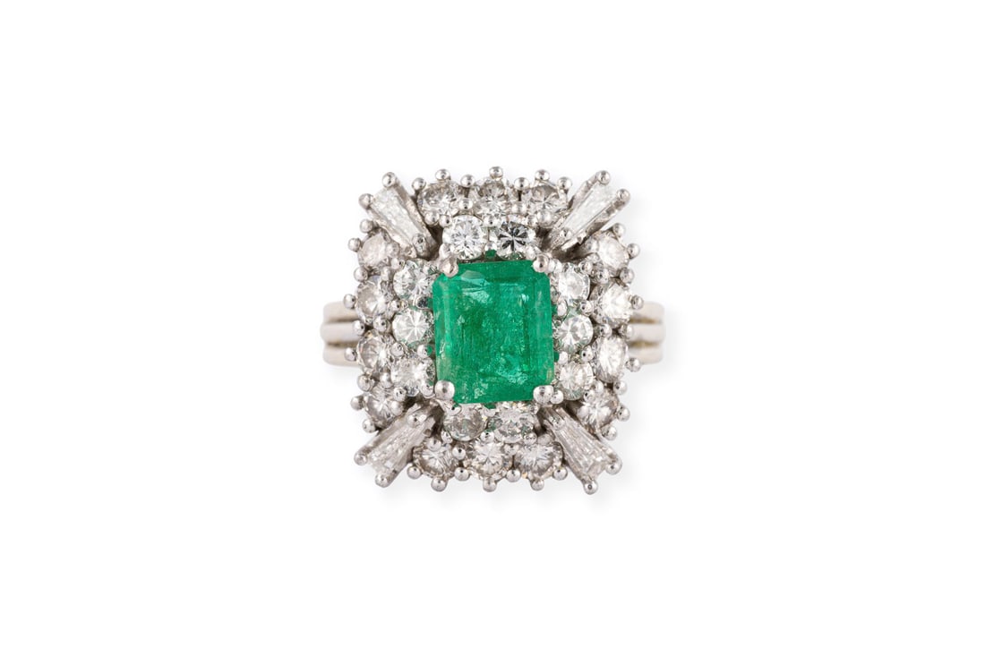 SMARAGD COCKTAIL RING: SMARAGD COCKTAIL RING WG 750 (getestet). Ringmass: ca. 51. Ringkopfmasse: ca. 16,6 x 15,5 mm. Ges.-Gew.: ca. 6,4 g. Ring, besetzt mit einem Smaragd von ca. 1.00 ct. und Diamanten im Trapez- und Brilla