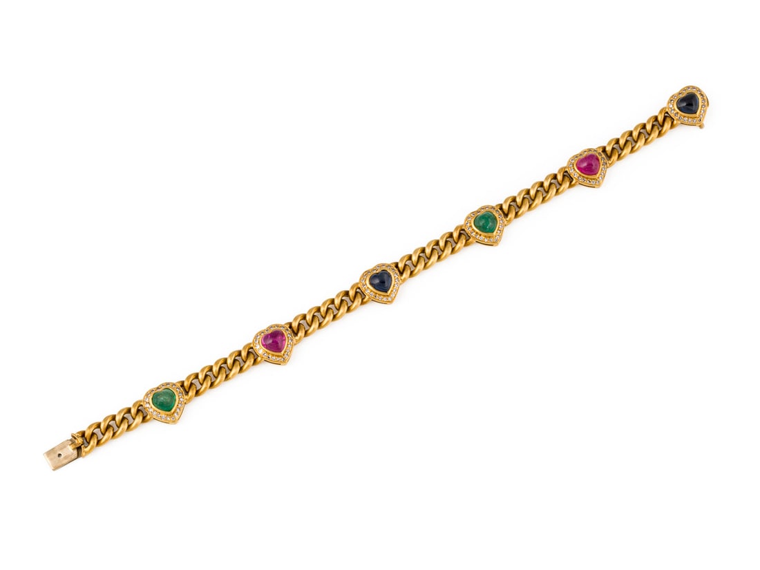 TUTTI FRUTTI HERZ ARMBAND: TUTTI FRUTTI HERZ ARMBAND GG 750. Masse: ca. 18,5 cm. B.: ca. 10,8 mm. Ges.-Gew.: ca. 27,4 g. Panzerarmband, besetzt mit 6 Herzfoermigen Cabochons: 2 Rubine zus. ca. 1.60 ct., 2 Saphire zus. ca. 1.60
