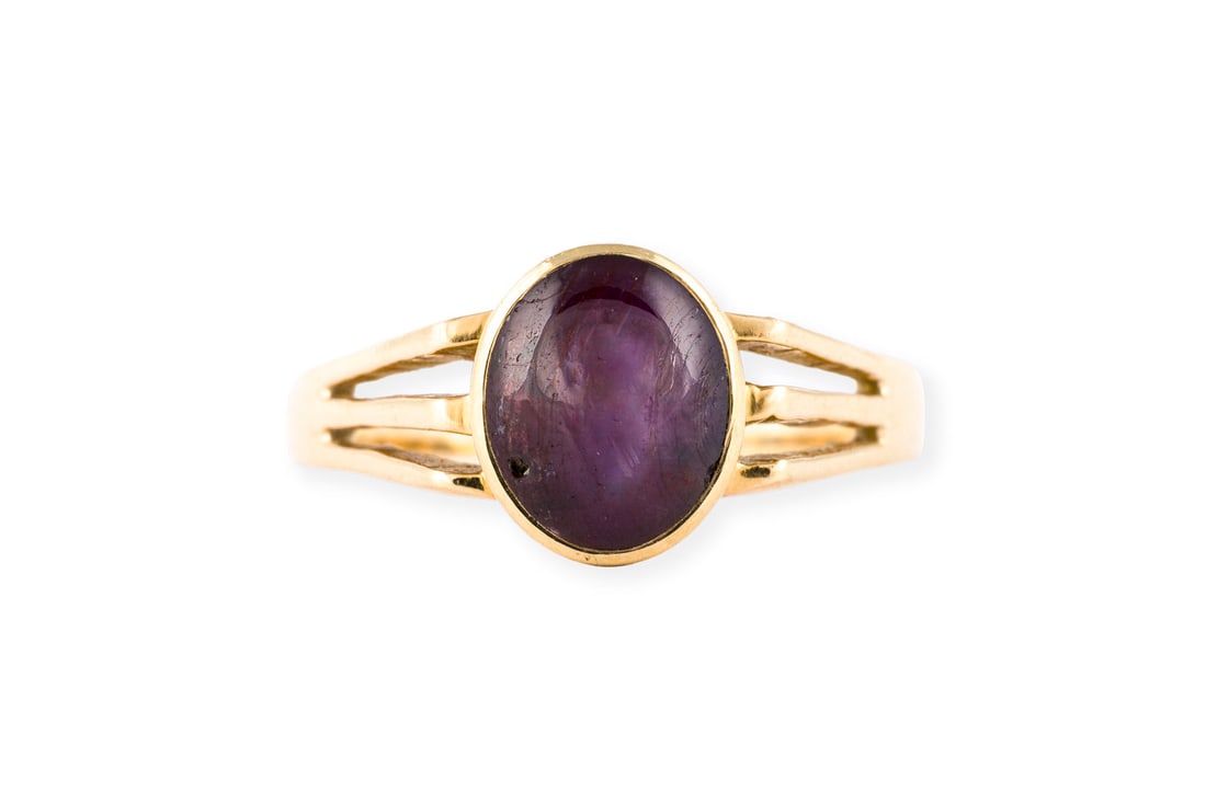 SOLITAER RING: SOLITAER RING GG 750. Ringmass: ca. 58. Ringbreite: ca. 9,9 mm. Ges.-Gew.: ca. 4,0 g. Ring, besetzt mit einem lila Farbstein mit Chatoyance.