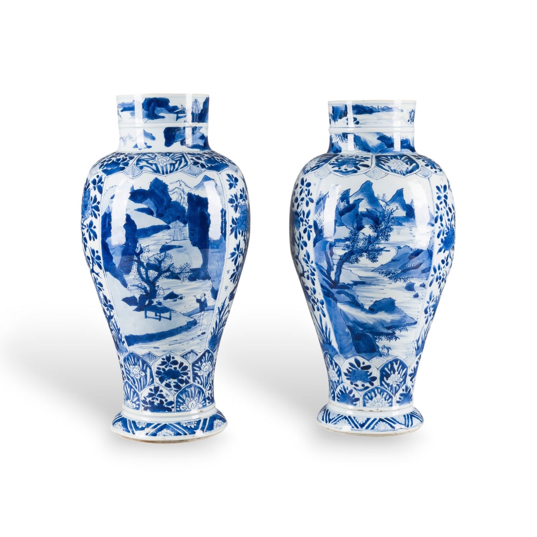 EIN PAAR BLAU-WEISSE BALUSTERVASEN: A PAIR OF BLUE AND WHITE BALUSTER VASES China, Kangxi period Porcelain. H. 44-45 cm. The vases are decorated with landscape scenes and flowers and bear a leaf mark on the base. With traces of age and 