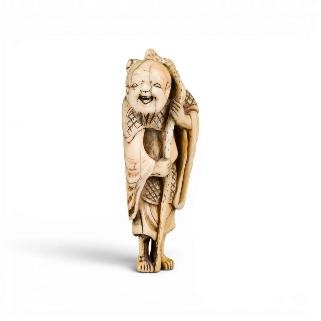 EIN NETSUKE DES TEKKAI SENNIN AUS ELFENBEIN*: AN IVORY NETSUKE OF TEKKAI SENNIN* Japan, 19th century Ivory. H. 6.9 cm. With traces of use, partially cracked and damaged. CITES marketing certificate is available. Please note that due to the curren