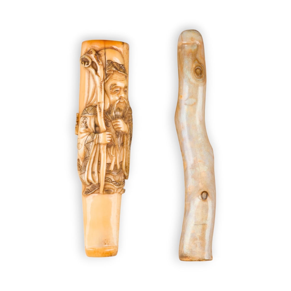 ZWEI ZIGARETTENSPITZEN: TWO CIGARETTE HOLDERS Japan, 19th century or later Walrus tusk/coral. L. 8.9-9.6 cm. Including a walrus-tusk cigarette holder depicting Jurojin on one side and flowers on the other, signed "Shuko" in