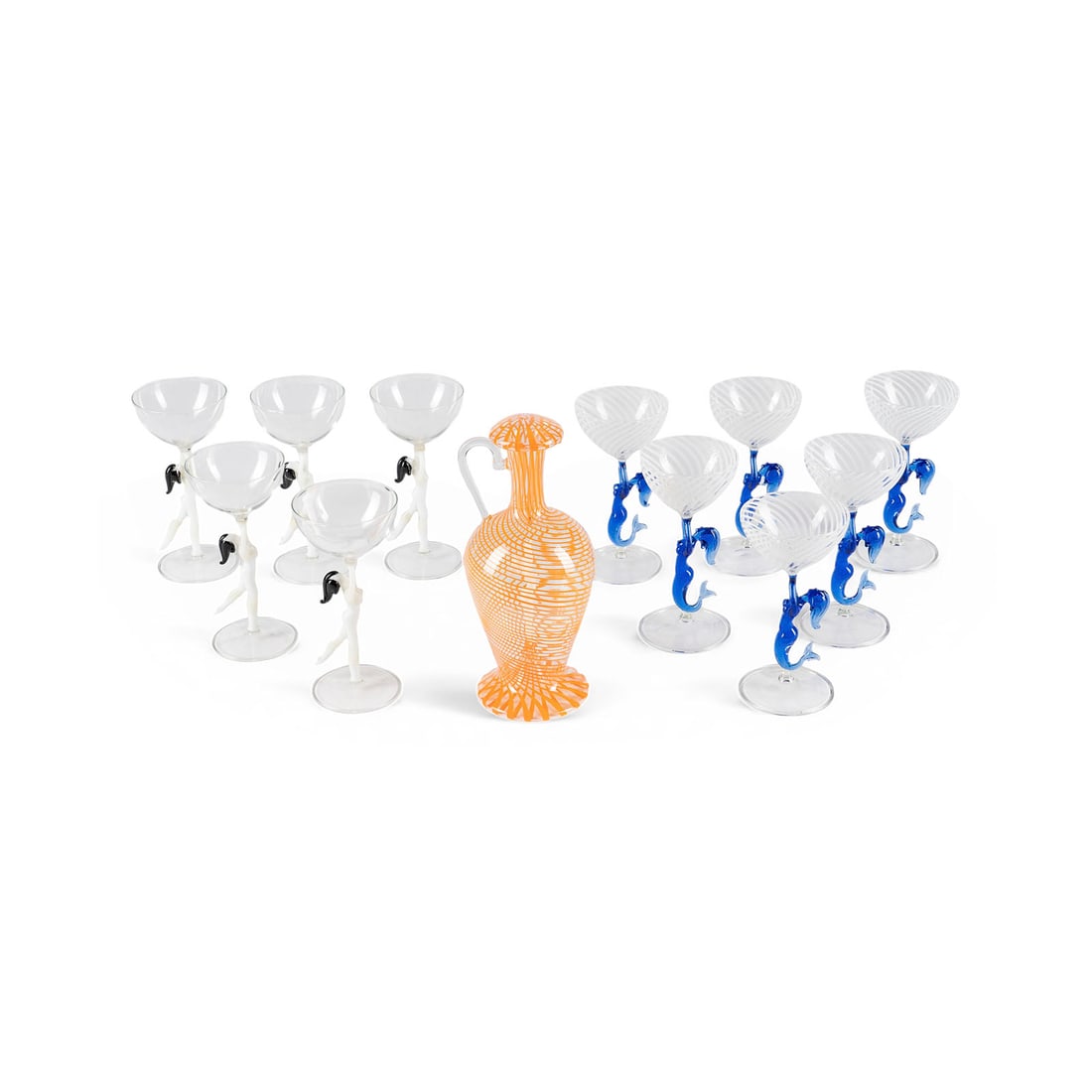 | 12-TEILIGES LIKOeRSET: 12-TEILIGES LIKOeRSET Deutsch/Oesterreich, Lauscha/Bimini, um 1930 Farbloses duennwandiges Glas, teilw. mit weissen und orangenen Faeden, Stiel in Form einer weiblichen Aktfigur aus weissem und
